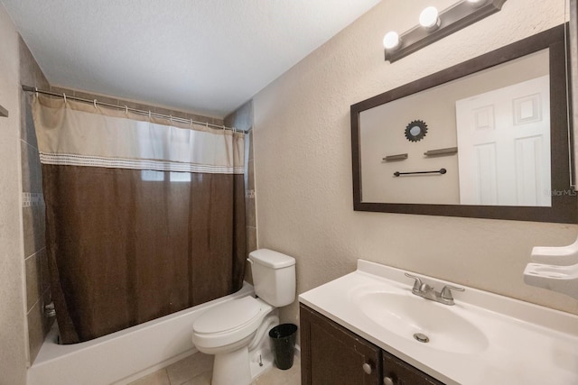 bathroom with vanity, a textured wall, toilet, tile patterned floors, and shower / tub combo
