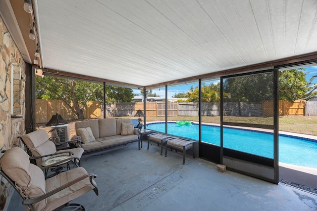 sunroom featuring an outdoor hangout area