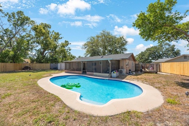 view of pool with a sunroom, a fenced backyard, a yard, and a fenced in pool