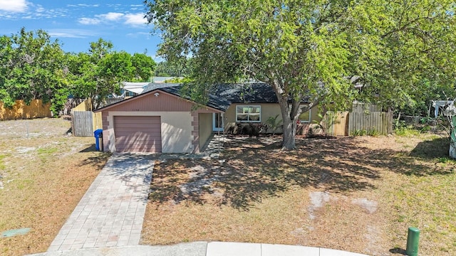 view of front of house featuring fence and decorative driveway
