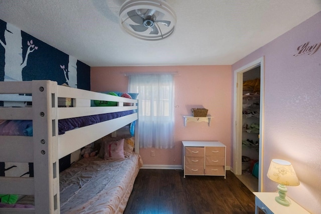 bedroom featuring baseboards and dark wood-style flooring
