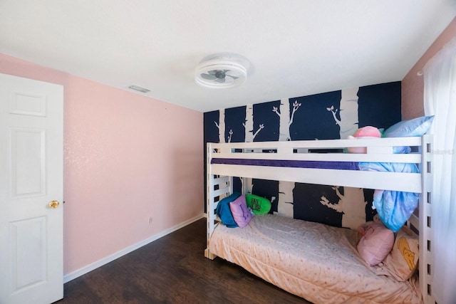 bedroom featuring baseboards and wood finished floors