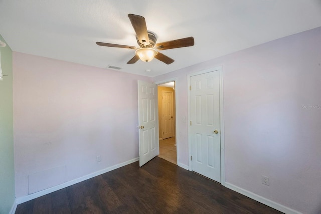 unfurnished bedroom featuring baseboards, a ceiling fan, wood finished floors, and visible vents