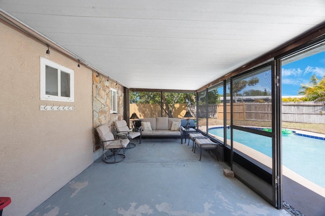 sunroom featuring an outdoor hangout area
