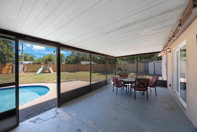 sunroom / solarium featuring outdoor dining area