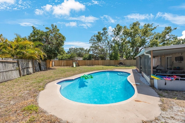 view of swimming pool with a fenced in pool, a fenced backyard, and a lawn