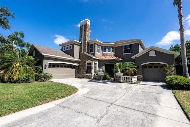 16637 Ashton Green Dr, Lutz, FL 33558 - view of front facade with driveway, a chimney, an attached garage, stone siding, and stucco siding