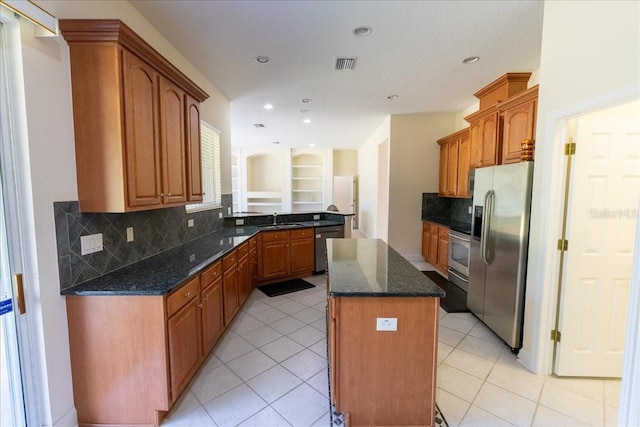 16637 Ashton Green Dr, Lutz, FL 33558 - kitchen with decorative backsplash, a kitchen island, visible vents, appliances with stainless steel finishes, and a sink