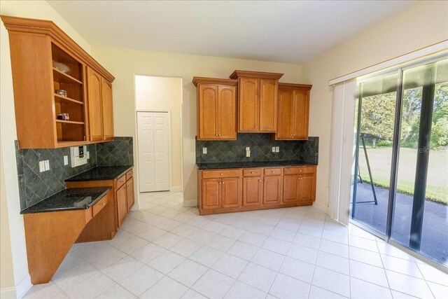 16637 Ashton Green Dr, Lutz, FL 33558 - kitchen featuring brown cabinets, backsplash, open shelves, and baseboards