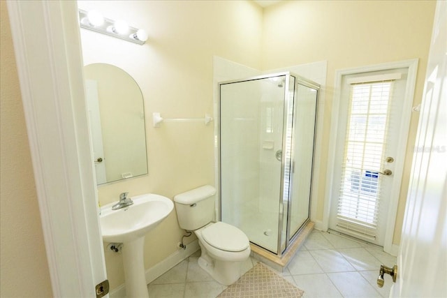 16637 Ashton Green Dr, Lutz, FL 33558 - bathroom with toilet, tile patterned floors, a shower stall, and baseboards