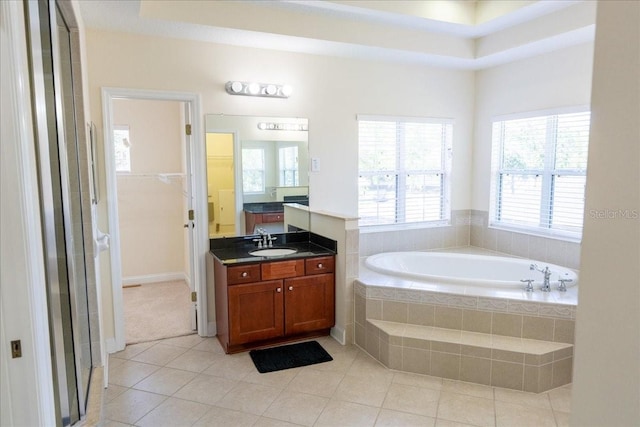 16637 Ashton Green Dr, Lutz, FL 33558 - full bath with tile patterned floors, a shower stall, a bath, and vanity