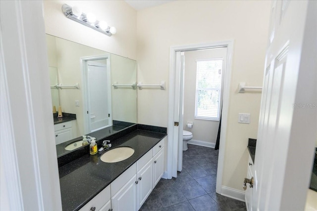 16637 Ashton Green Dr, Lutz, FL 33558 - full bathroom featuring toilet, tile patterned floors, baseboards, and vanity