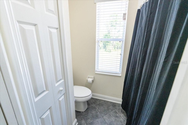 16637 Ashton Green Dr, Lutz, FL 33558 - bathroom featuring toilet, tile patterned floors, and baseboards