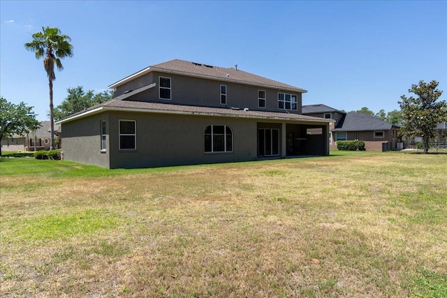 16637 Ashton Green Dr, Lutz, FL 33558 - back of house with a lawn and stucco siding