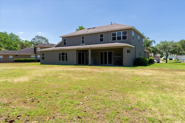 16637 Ashton Green Dr, Lutz, FL 33558 - rear view of property with a yard and stucco siding