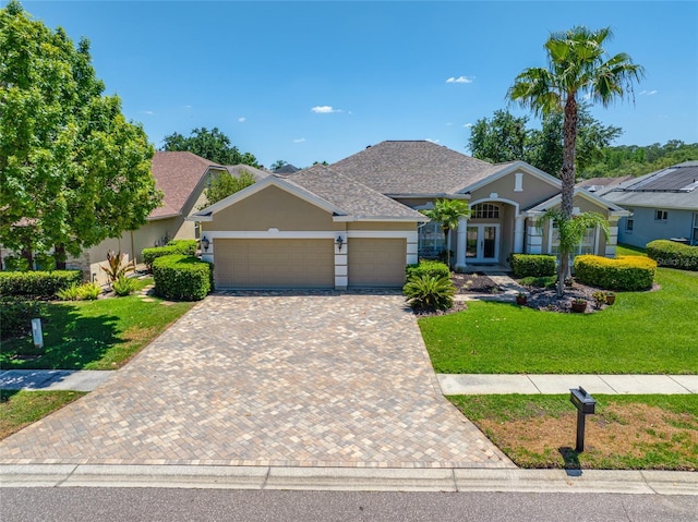 craftsman-style home featuring an attached garage, decorative driveway, stucco siding, and a front yard