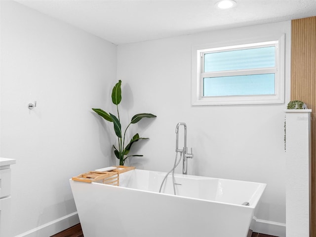 326 176th Avenue Cir, Redington Shores, FL 33708 - full bathroom with a freestanding tub, baseboards, and wood finished floors