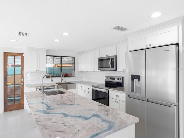 326 176th Avenue Cir, Redington Shores, FL 33708 - kitchen with stainless steel appliances, a sink, backsplash, healthy amount of natural light, and recessed lighting