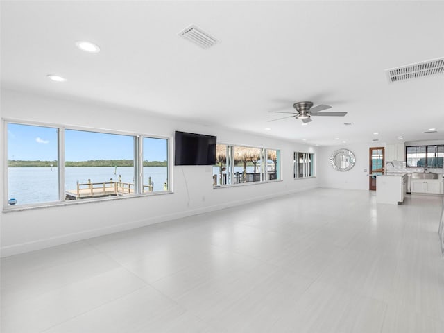 326 176th Avenue Cir, Redington Shores, FL 33708 - unfurnished living room with recessed lighting, a sink, ceiling fan, and baseboards