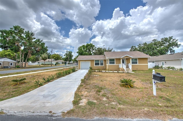5939 14th St, Zephyrhills, FL 33542 - view of front of house featuring an attached garage, stucco siding, driveway, and a front yard