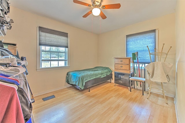 5939 14th St, Zephyrhills, FL 33542 - bedroom with baseboards, ceiling fan, and wood finished floors