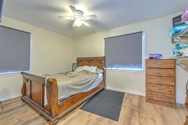 5939 14th St, Zephyrhills, FL 33542 - bedroom featuring ceiling fan, baseboards, and light wood finished floors