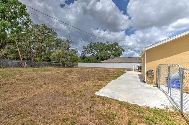 5939 14th St, Zephyrhills, FL 33542 - view of yard featuring a fenced backyard and a patio area