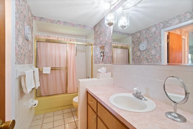 7534 Culberson Dr, Port Richey, FL 34668 - bathroom featuring tile patterned floors, vanity, toilet, enclosed tub / shower combo, and wallpapered walls