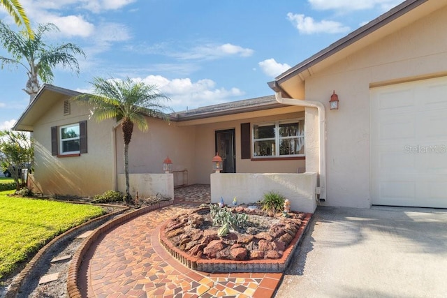 7534 Culberson Dr, Port Richey, FL 34668 - doorway to property featuring a garage, driveway, and stucco siding