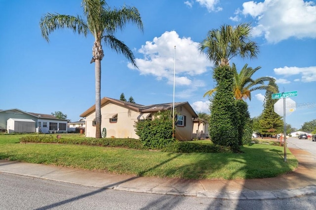7534 Culberson Dr, Port Richey, FL 34668 - view of property exterior with a lawn and stucco siding