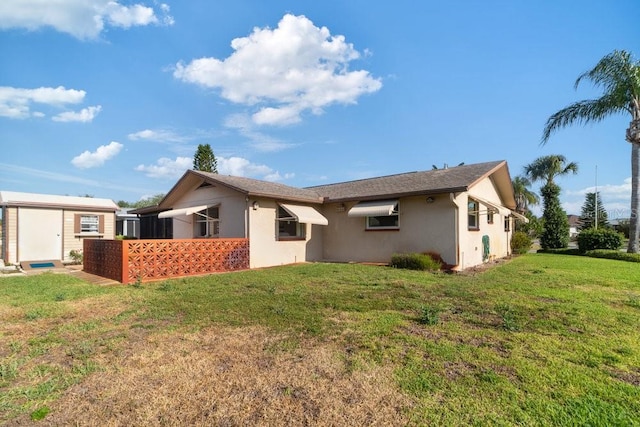 7534 Culberson Dr, Port Richey, FL 34668 - back of property featuring an outbuilding, stucco siding, a yard, and a shed