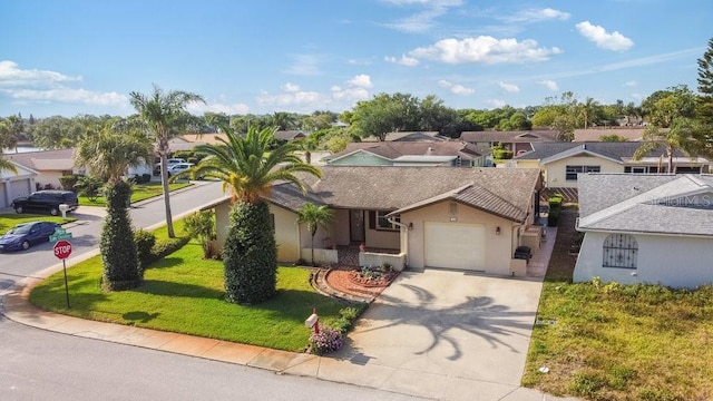 7534 Culberson Dr, Port Richey, FL 34668 - view of front of house with a garage, stucco siding, a residential view, and concrete driveway