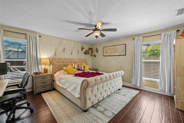 bedroom featuring dark wood-style flooring, a textured ceiling, and visible vents