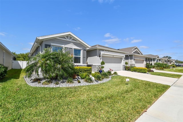 view of front of property featuring a front lawn, stone siding, a garage, stucco siding, and driveway