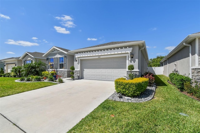 ranch-style home with fence, a front yard, stucco siding, an attached garage, and driveway