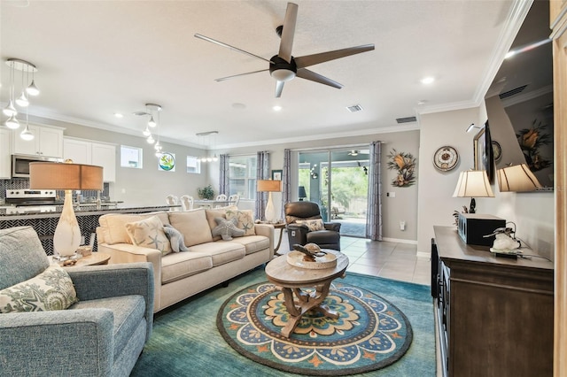 living area featuring visible vents, ornamental molding, ceiling fan, and light tile patterned floors