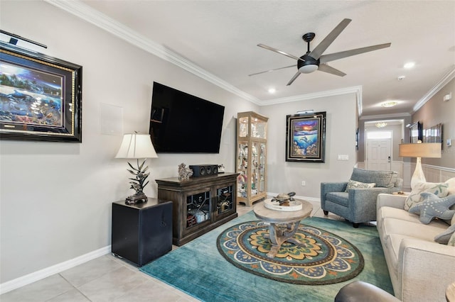 living area featuring light tile patterned floors, baseboards, ceiling fan, and ornamental molding