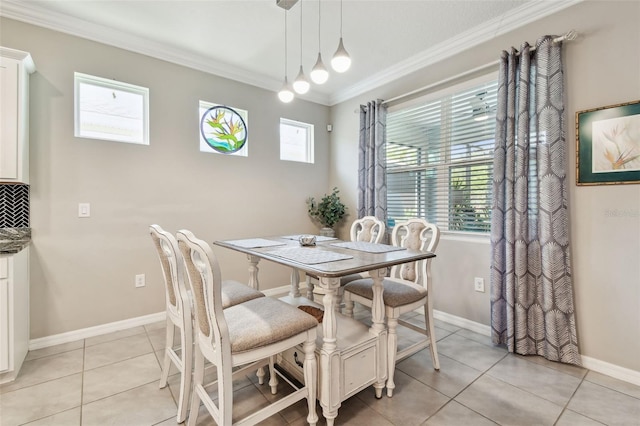 dining room with crown molding, baseboards, and light tile patterned floors