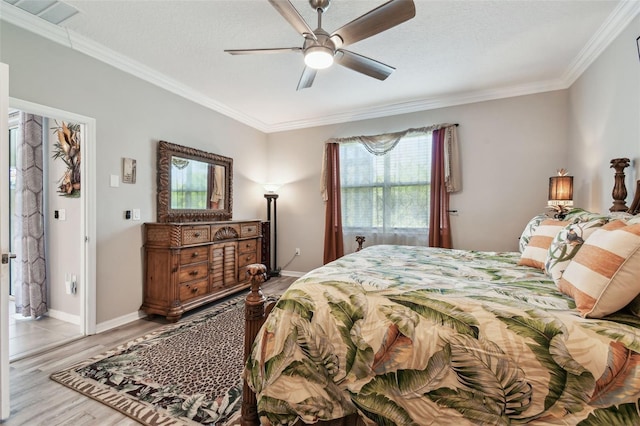 bedroom with ornamental molding, a ceiling fan, light wood finished floors, and visible vents