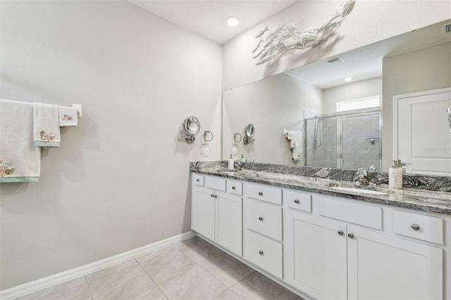bathroom featuring double vanity, baseboards, tile patterned floors, a shower stall, and a sink