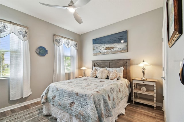 bedroom featuring baseboards, a ceiling fan, and wood finished floors