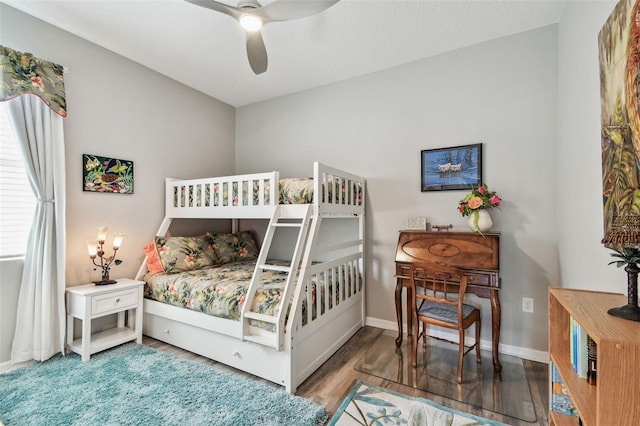 bedroom with baseboards, ceiling fan, and wood finished floors