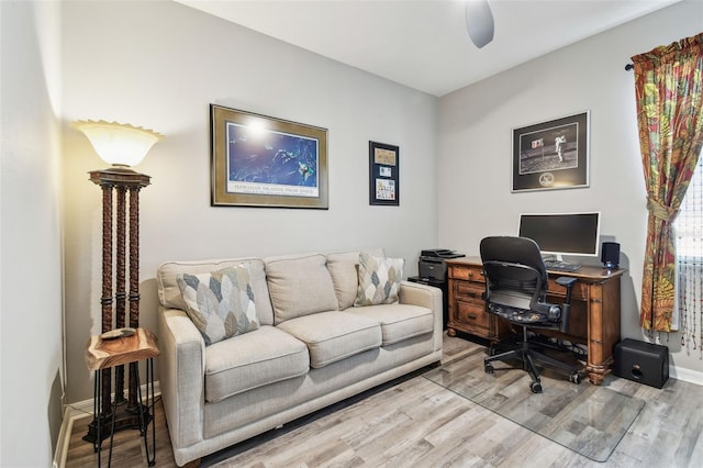 home office with baseboards, a ceiling fan, and wood finished floors