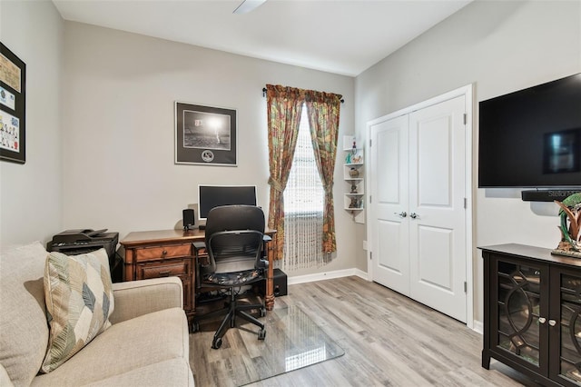 office space with light wood-style floors and baseboards