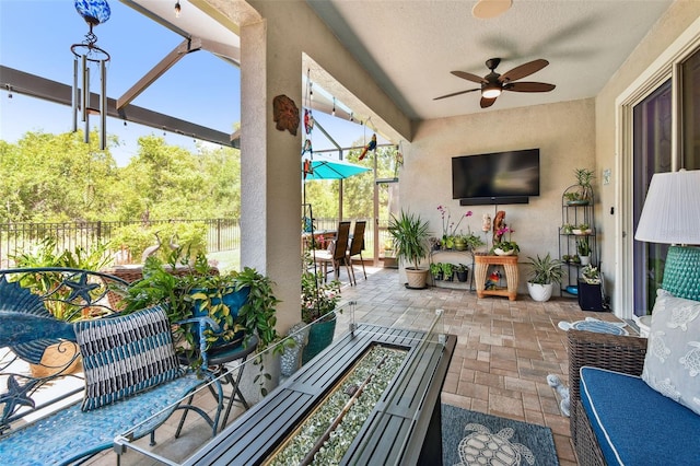 view of patio with fence and a ceiling fan