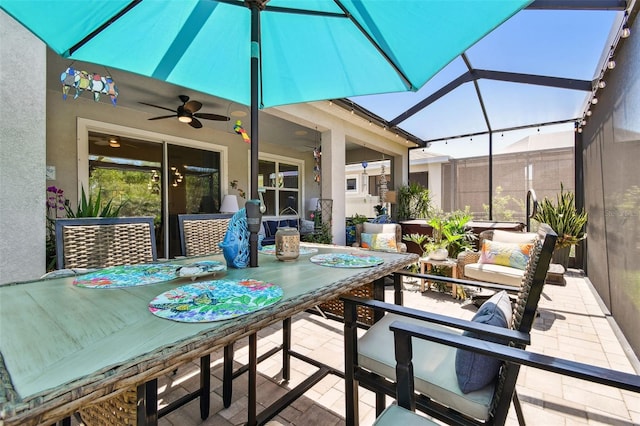sunroom / solarium featuring a ceiling fan and outdoor dining area