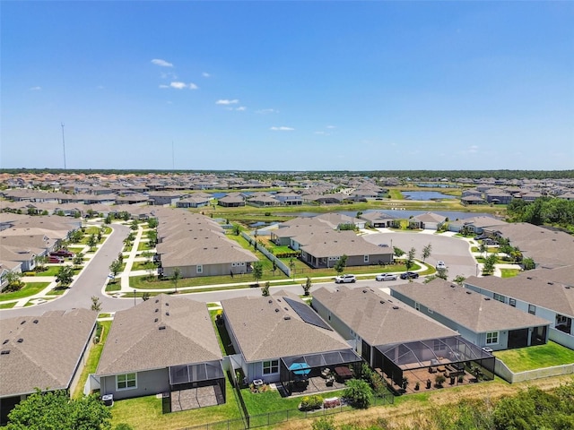 birds eye view of property with a water view and a residential view
