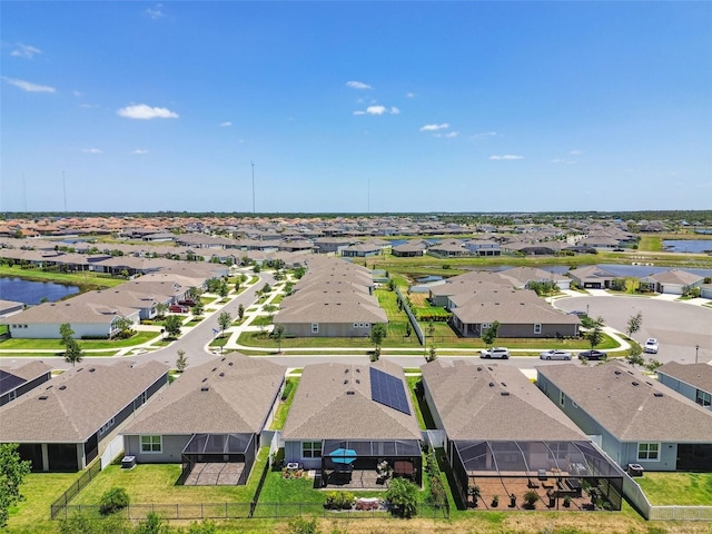 bird's eye view featuring a water view and a residential view