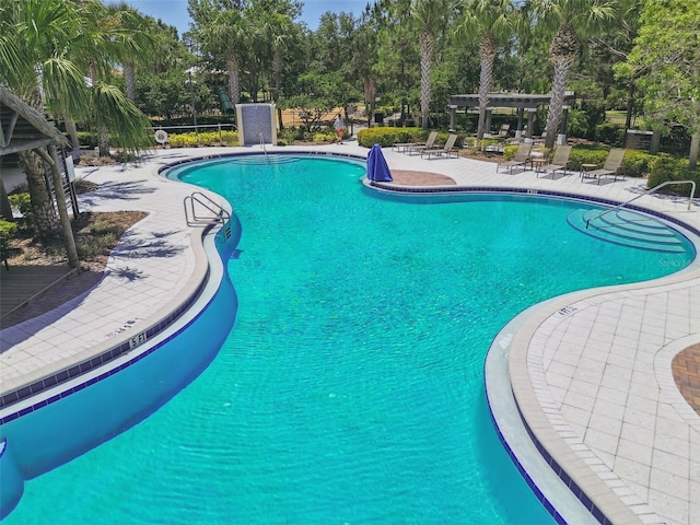 pool featuring a patio and a pergola