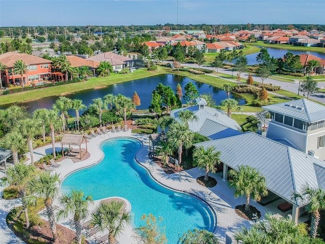 view of pool featuring a water view and a residential view